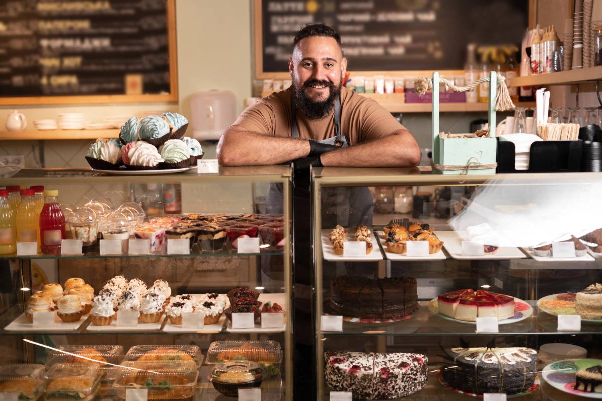 Photo: a bakery owner behind the pastry counter