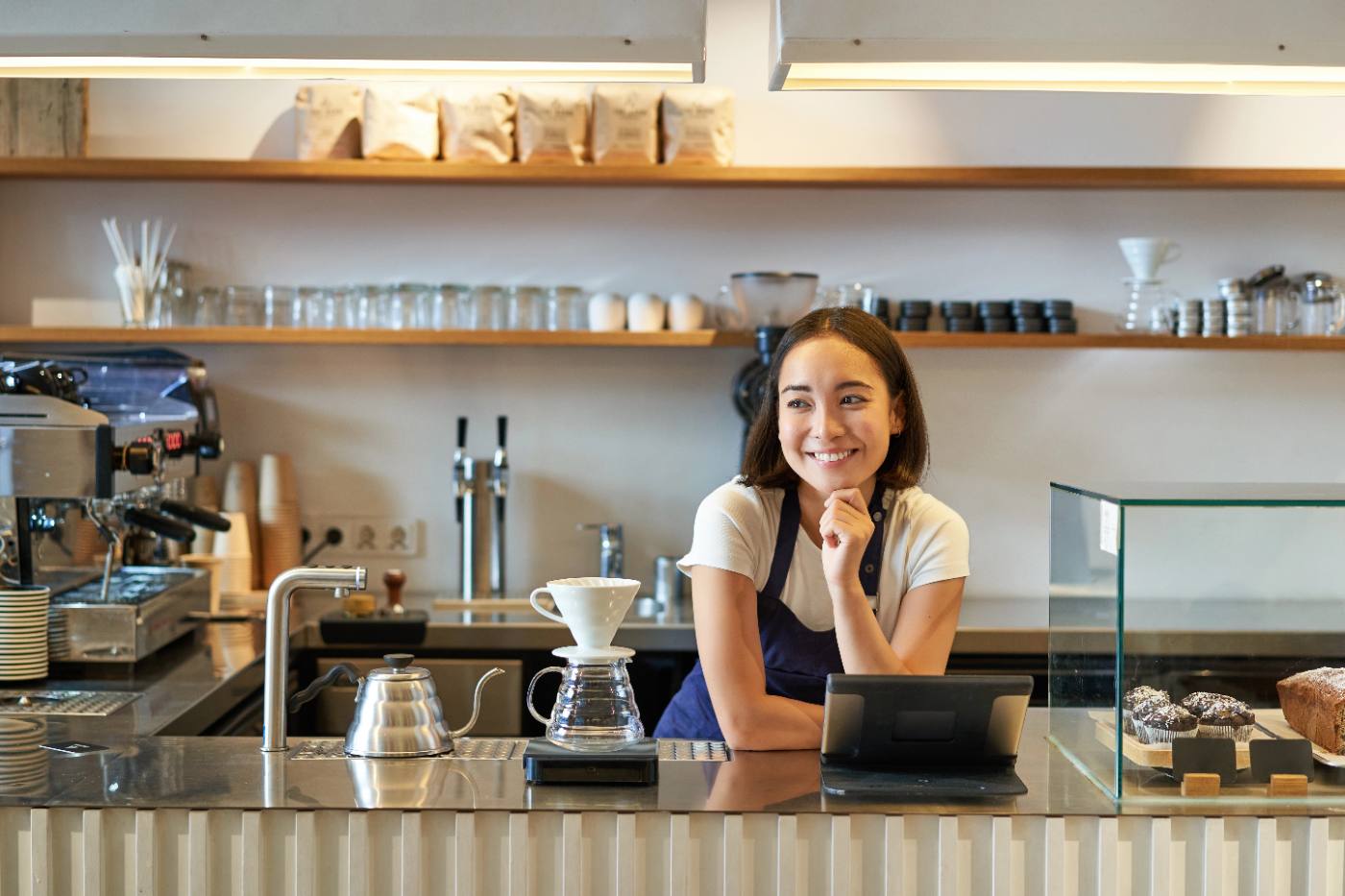 Photo: a small business owner at the counter of their shop