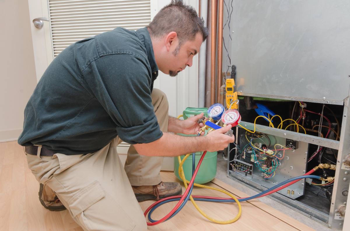 Photo: an HVAC technician servicing a unit