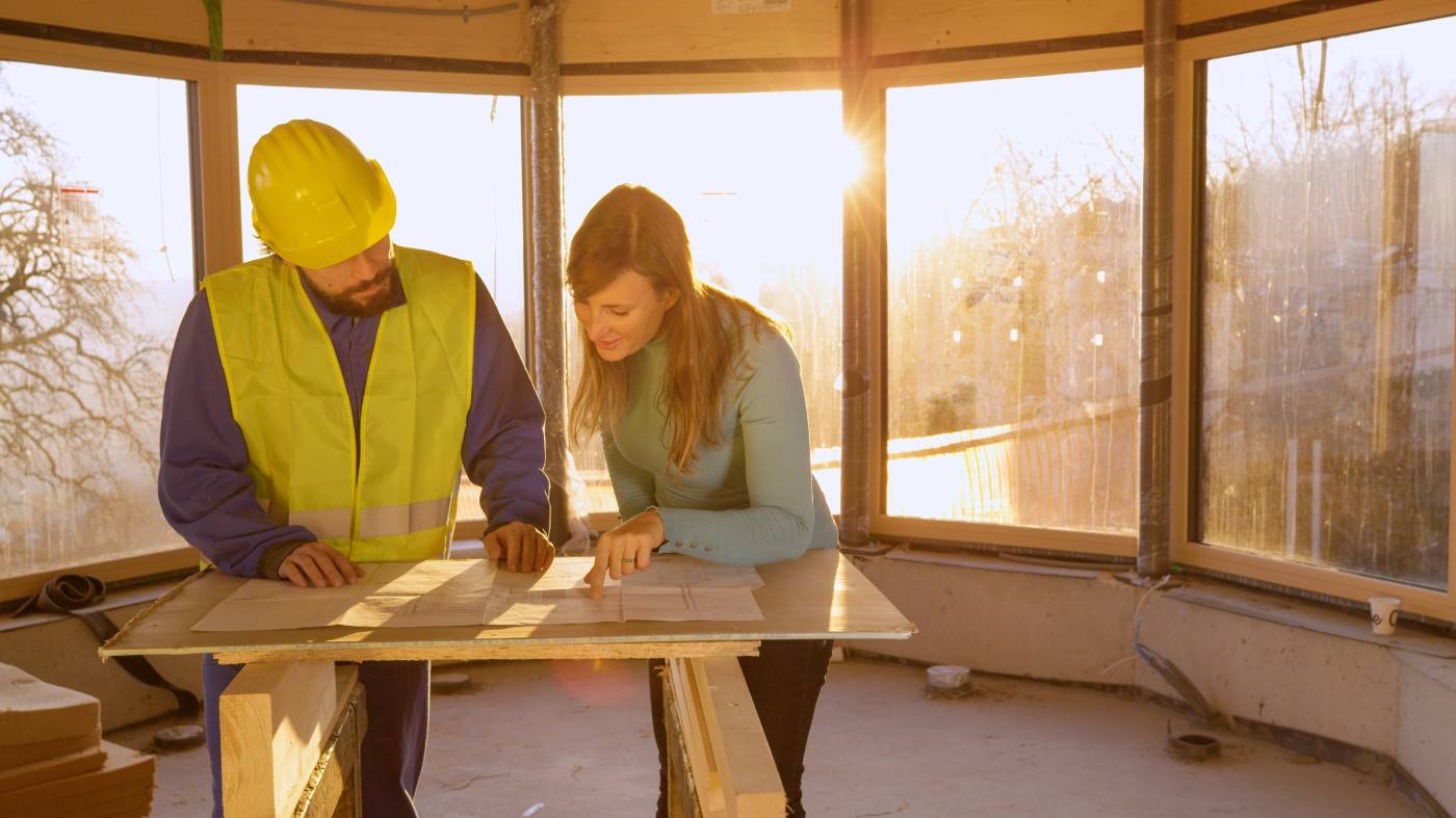 Photo: a contractor walking a job site with a Hatch producer