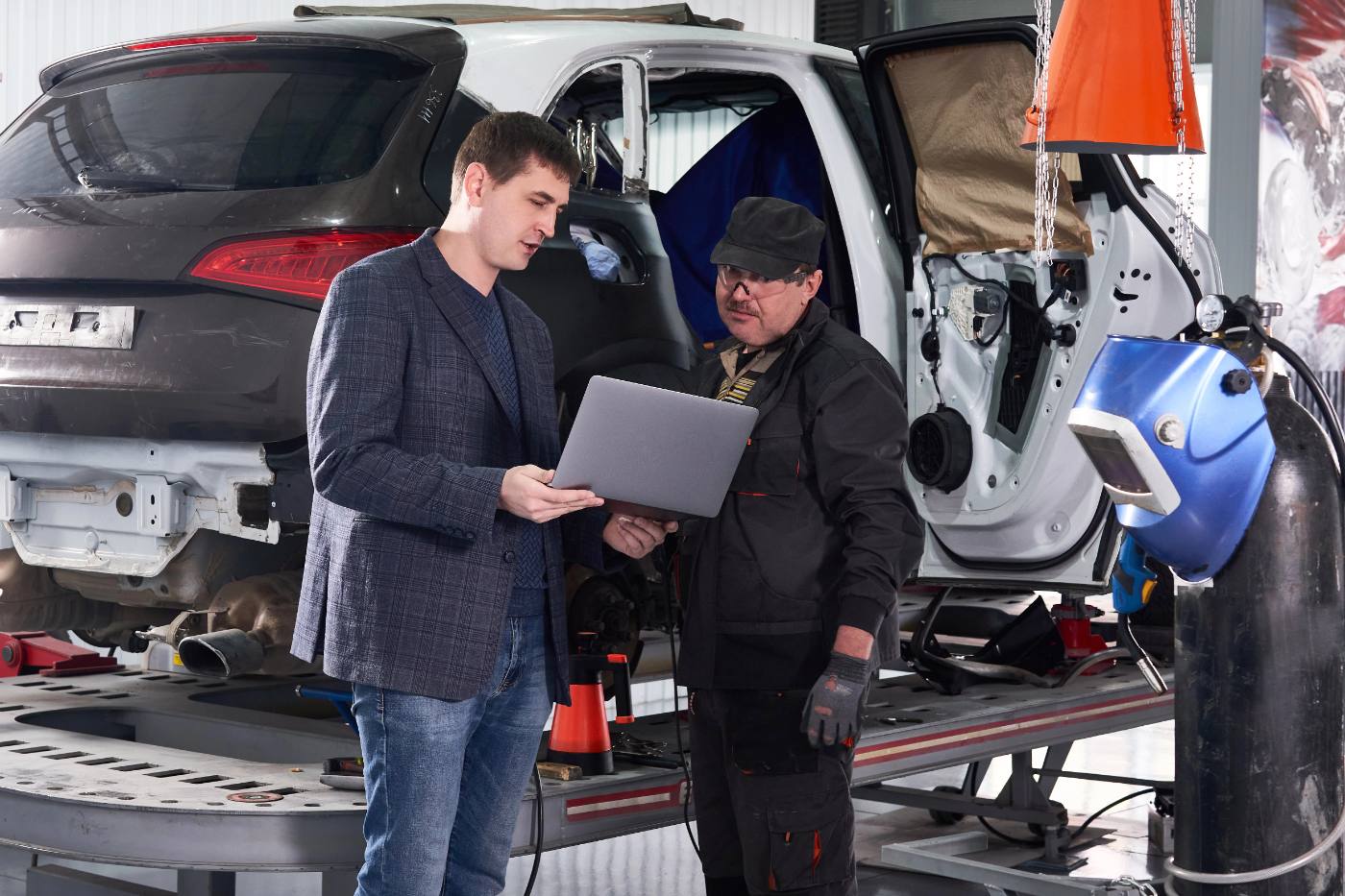 Photo: a shop owner reviewing a repair estimate with a Hatch producer