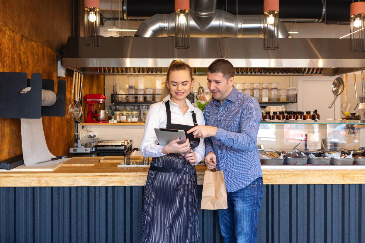Photo: an owner reviewing orders with a staff member