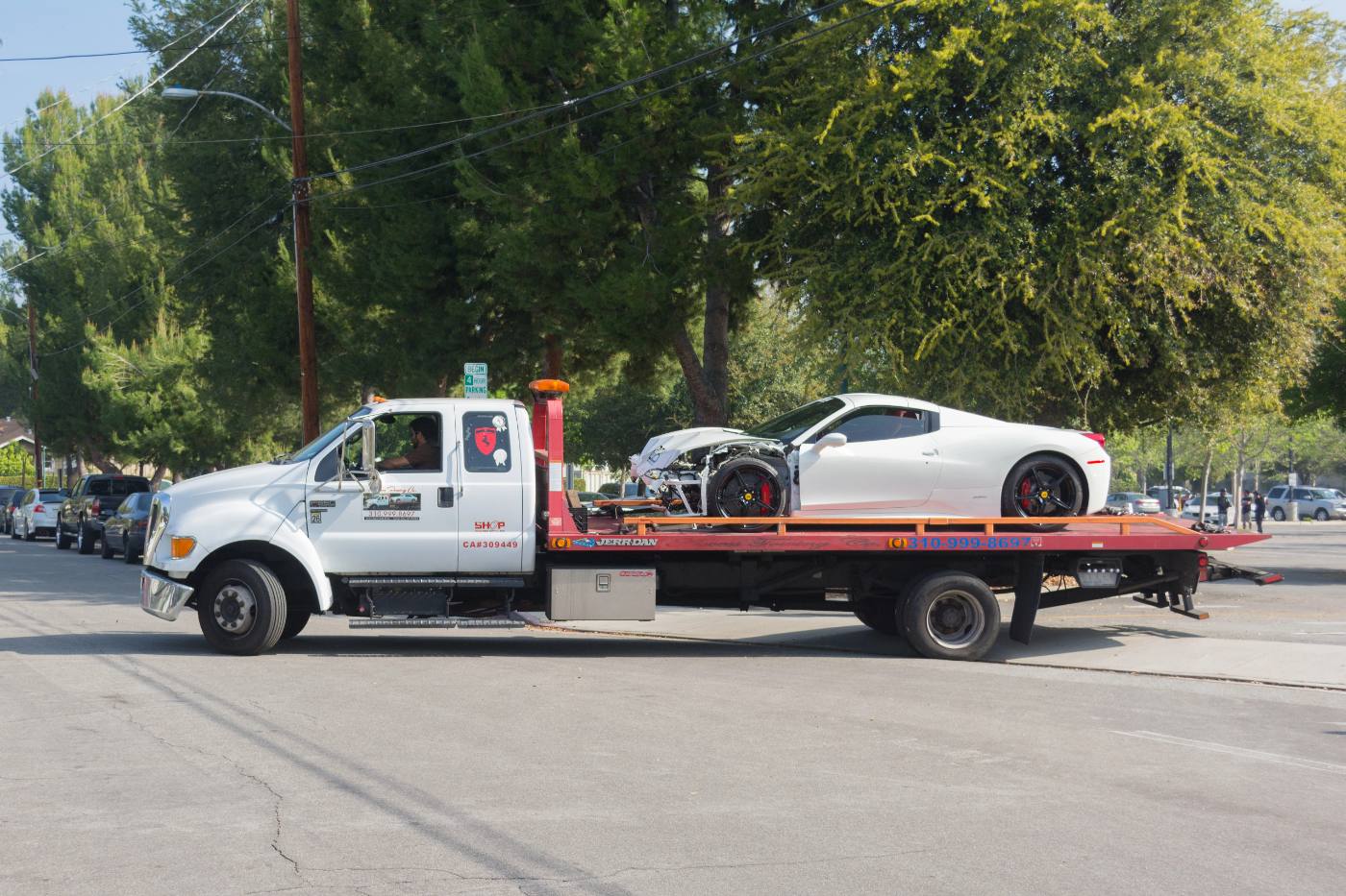Photo: a tow operator hooking up a vehicle roadside